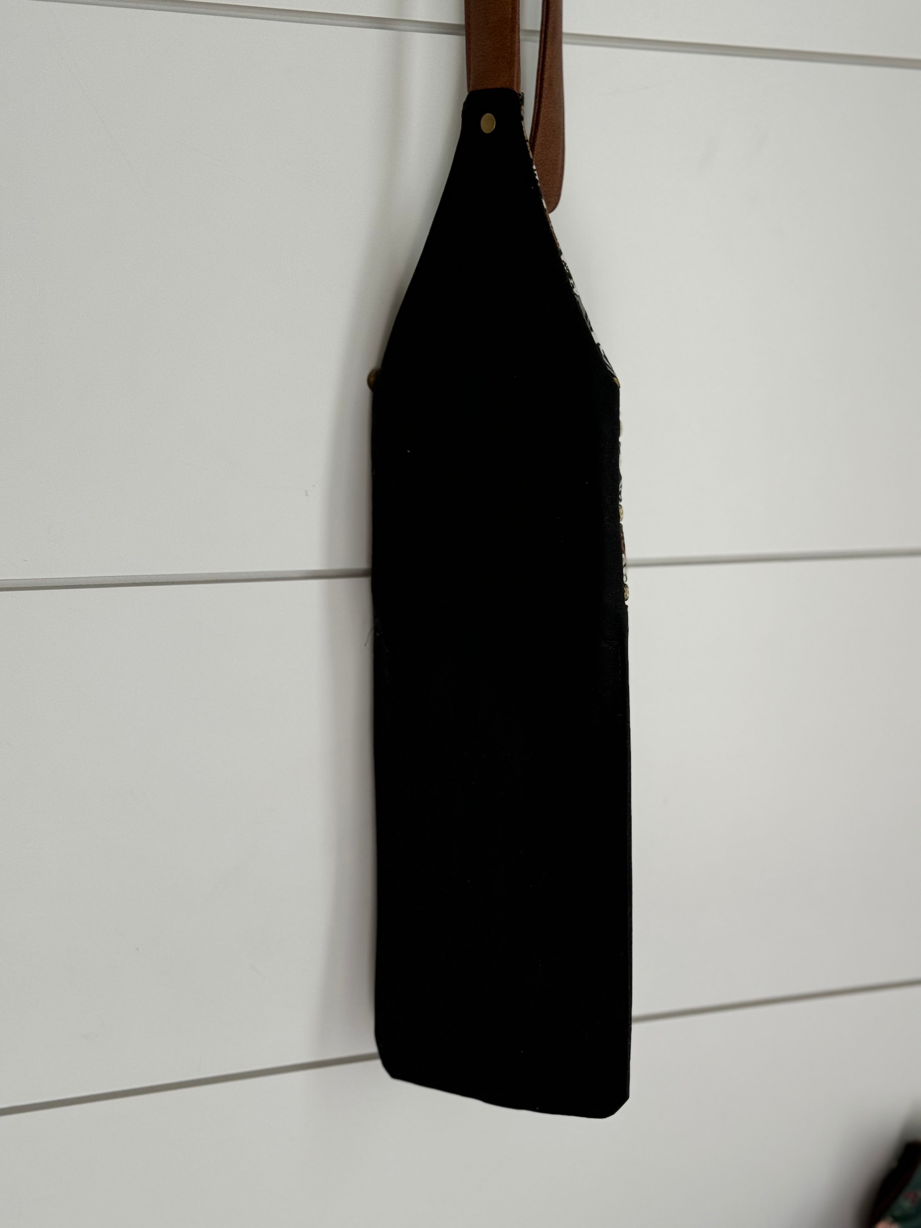 Rear view of Crossbody Bag shows Black solid waxed canvas panel