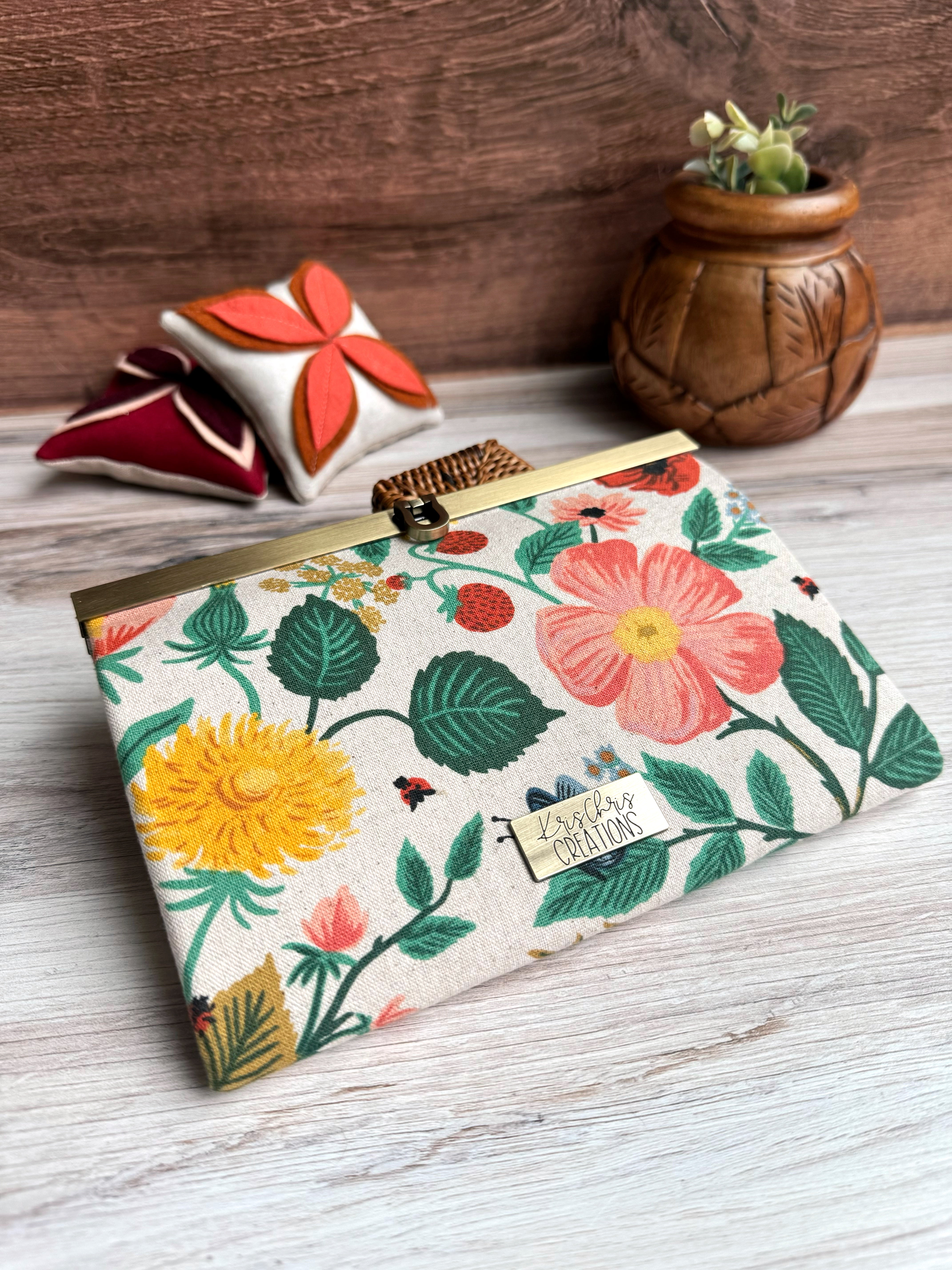 Floral canvas accordion wallet with Rifle Paper fabric, antique brass closure clasp along top edge and KrisChris antique brass label