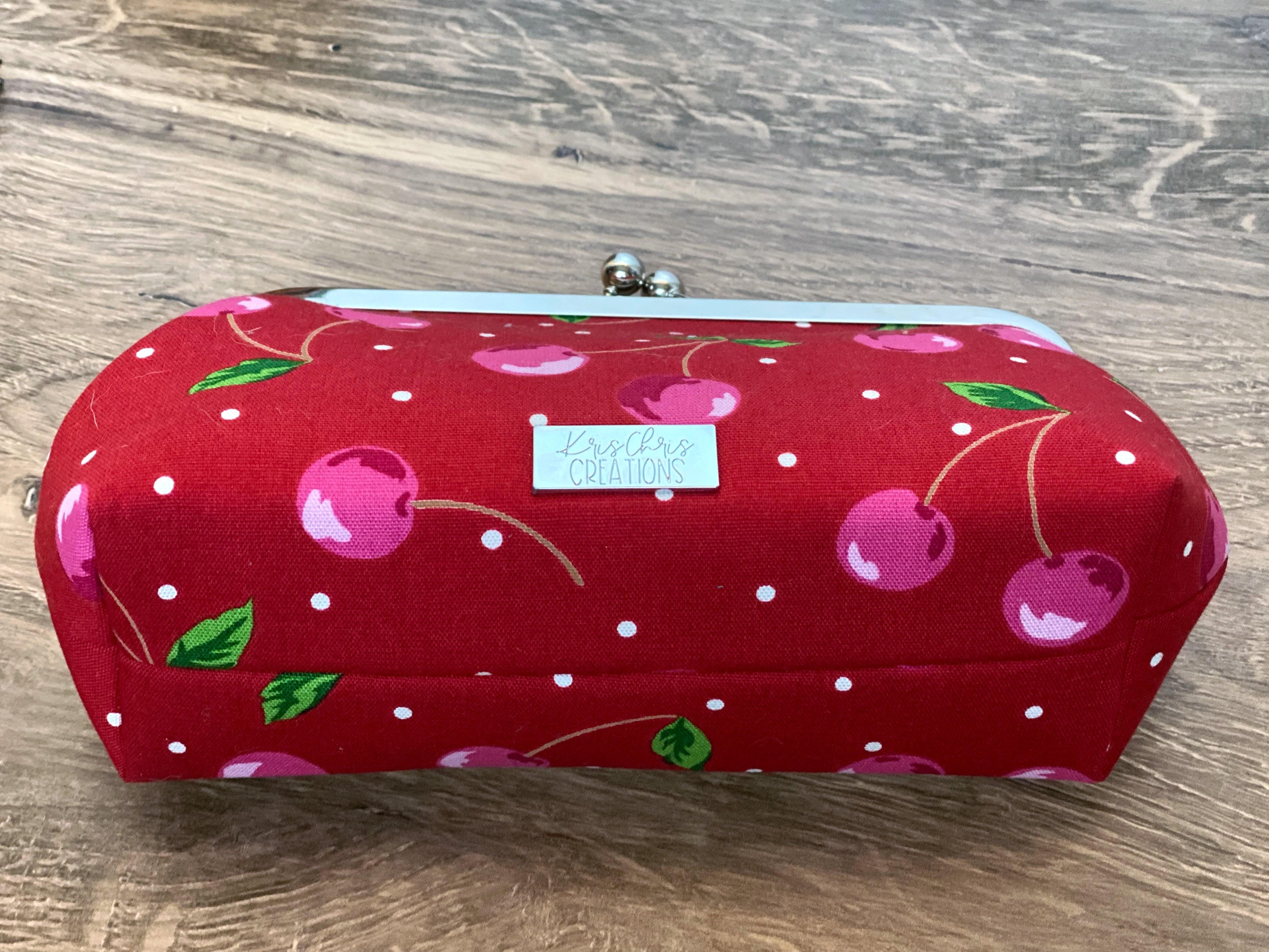 Cherry themed twistlock clutch with silver KrisChris label and silver hardware