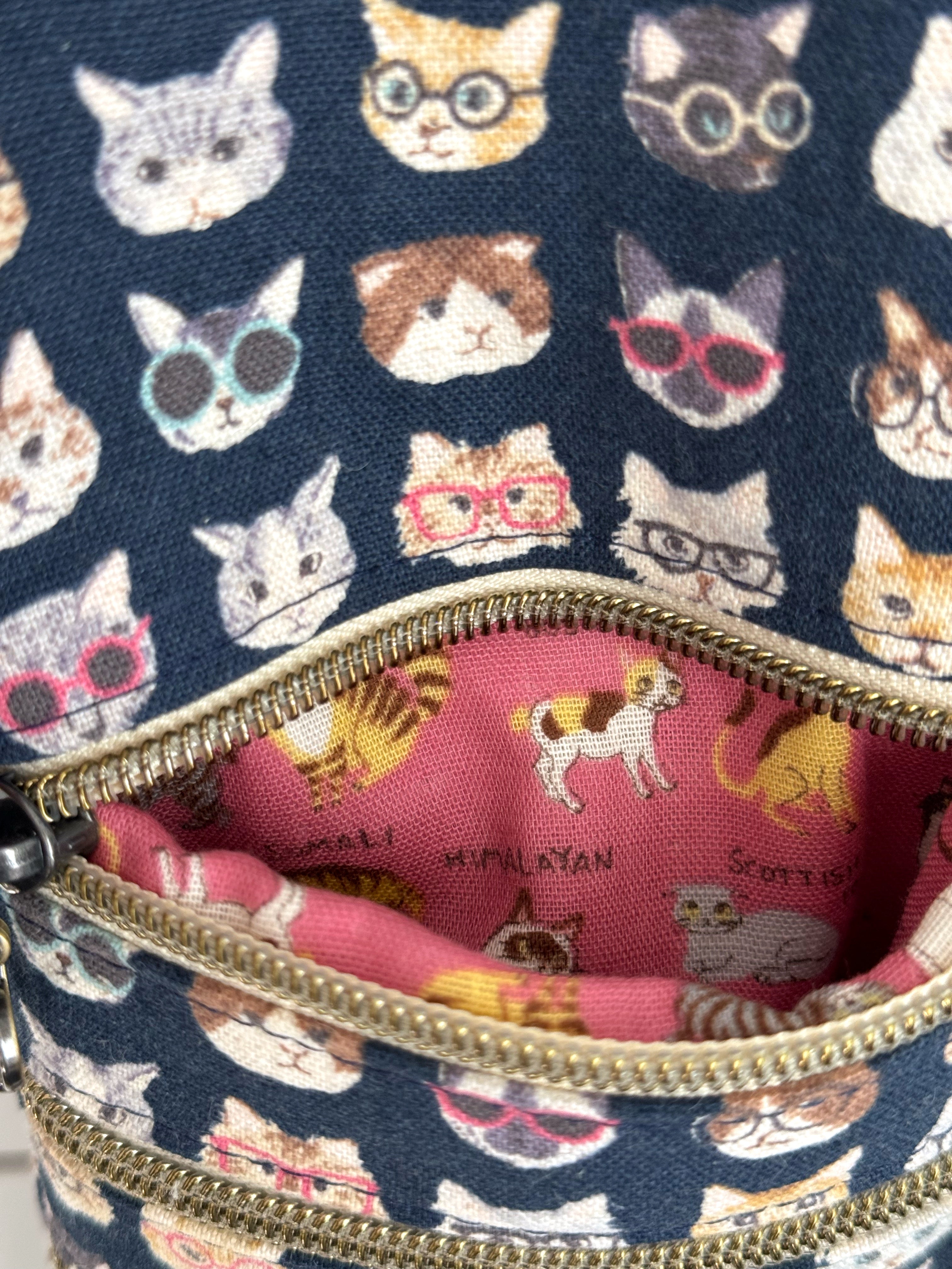 Opened pink zipper with cat breeds