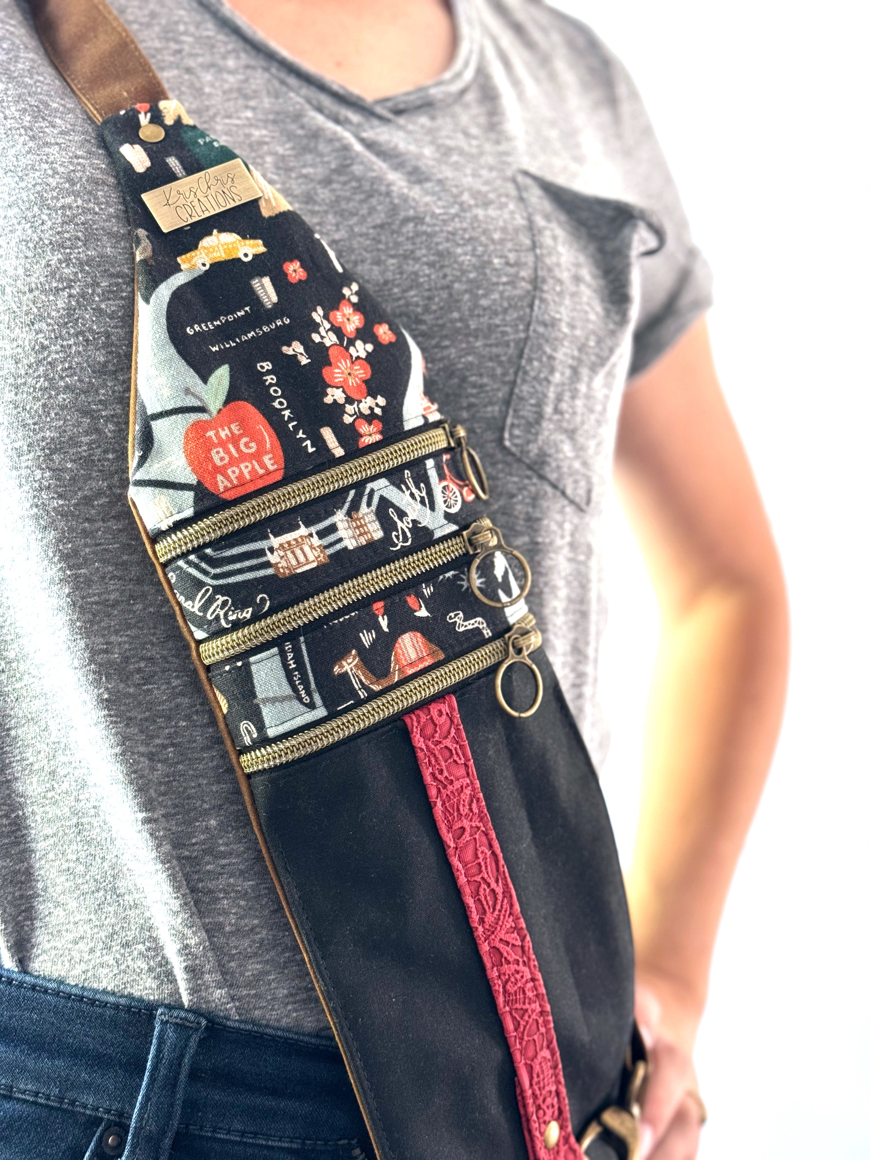 Bag worn across woman's chest with World Map fabric and 3 zippers
