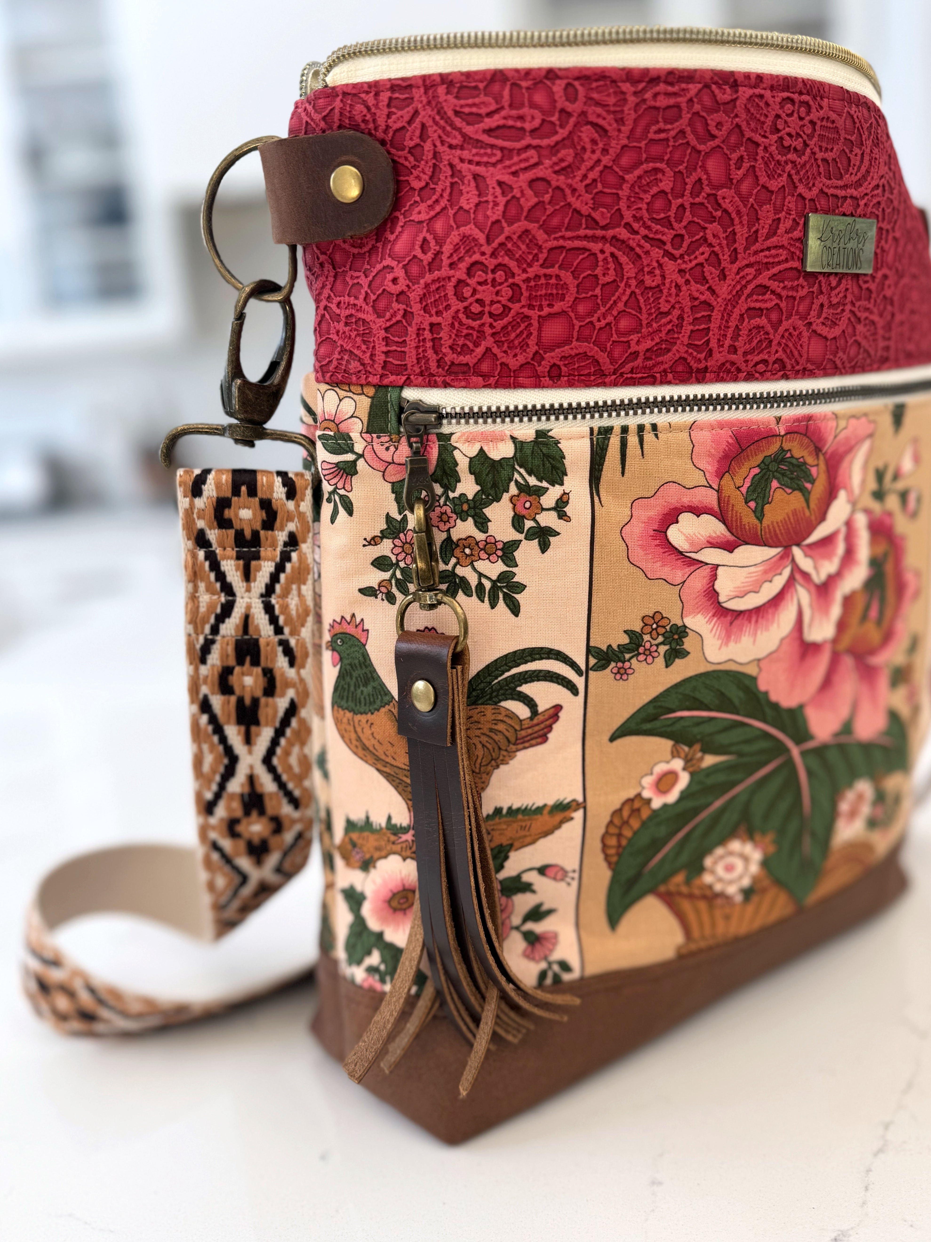 Floral tote bag with brown leather tassel attached. Lobster clasp easily attaches to bags and accessories.
