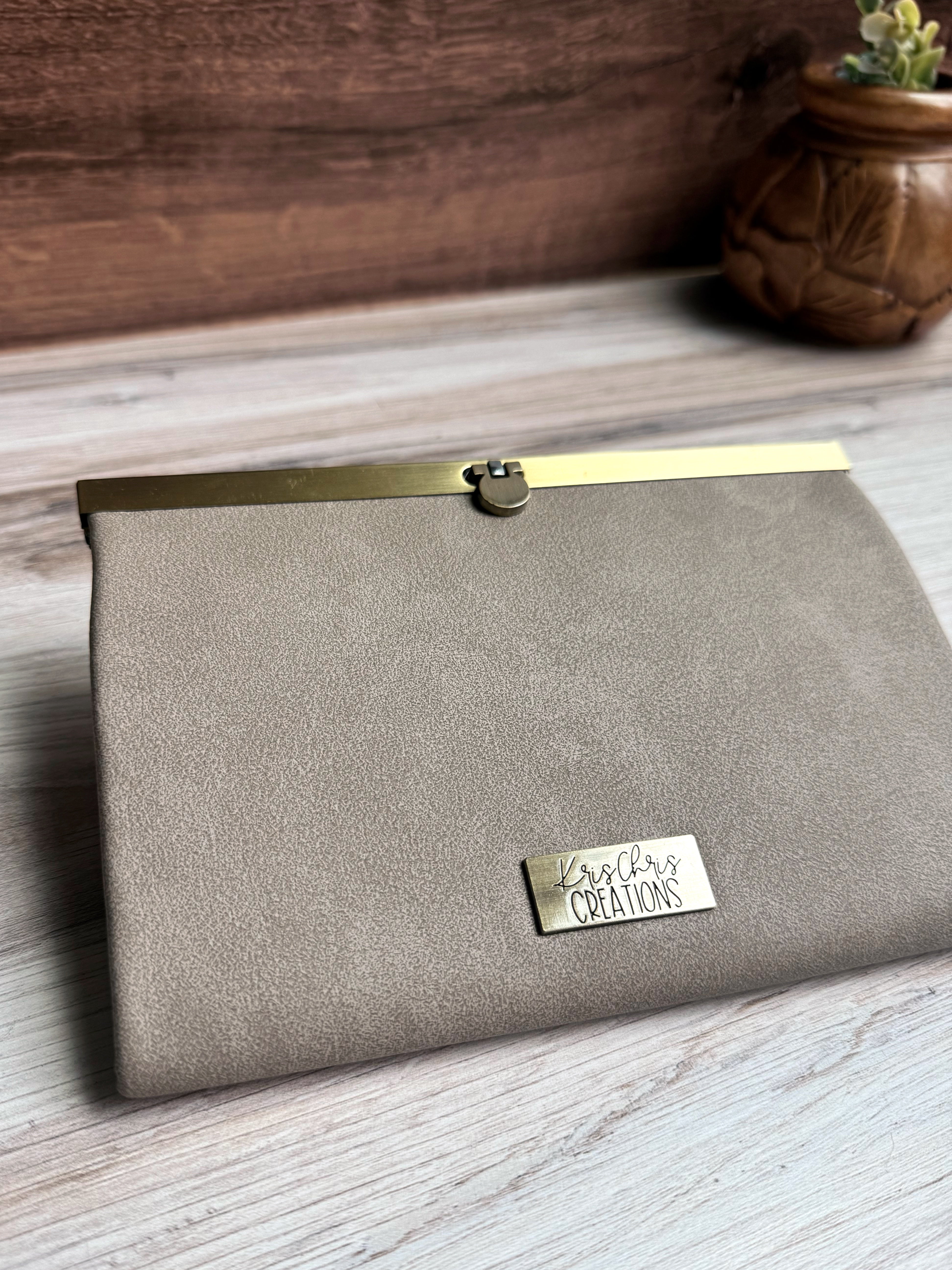 Gray/Tan accordion style wallet with a sleek exterior, antique brass metal clasp at top and coordinating KrisChris metal label.