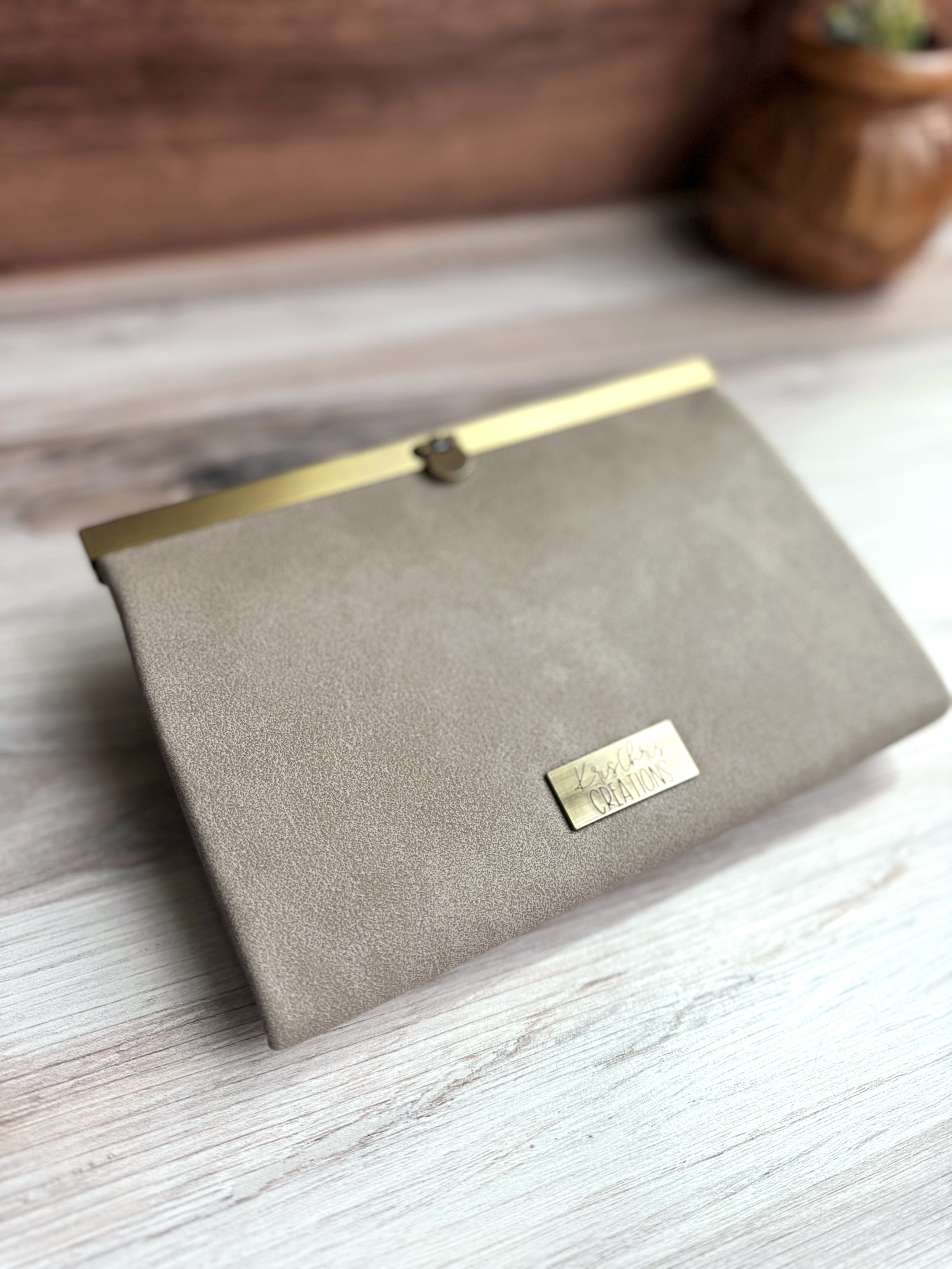 Gray/Tan accordion style wallet with a sleek exterior, antique brass metal clasp at top and coordinating KrisChris metal label.