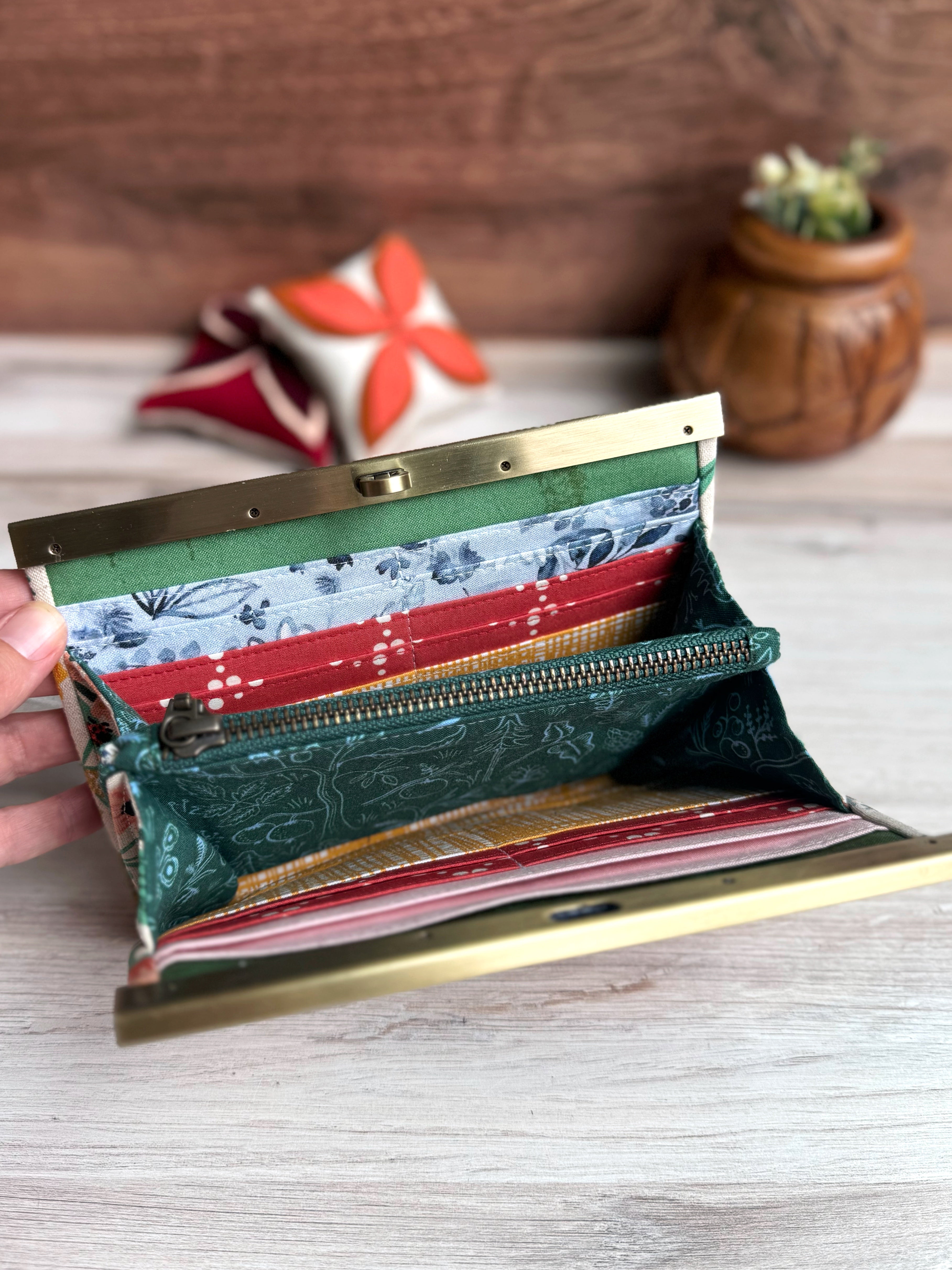 Interior of accordion wallet with interior zipper. Variety of fabric styles in yellow, blue, white, and red fabrics. Many card slots and storage.
