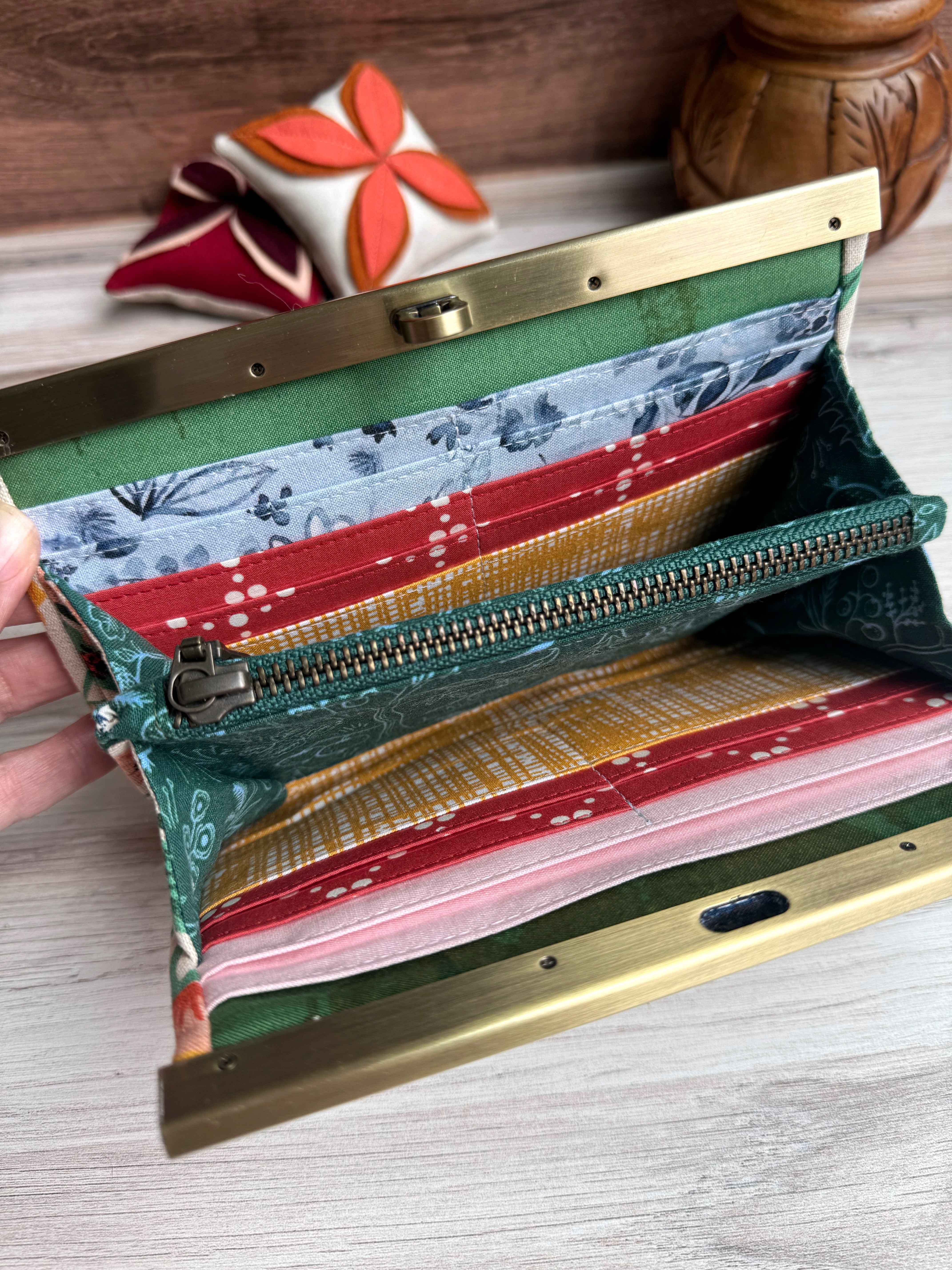 Interior of accordion wallet with interior zipper. Variety of fabric styles in yellow, blue, white, and red fabrics. Many card slots and storage.
