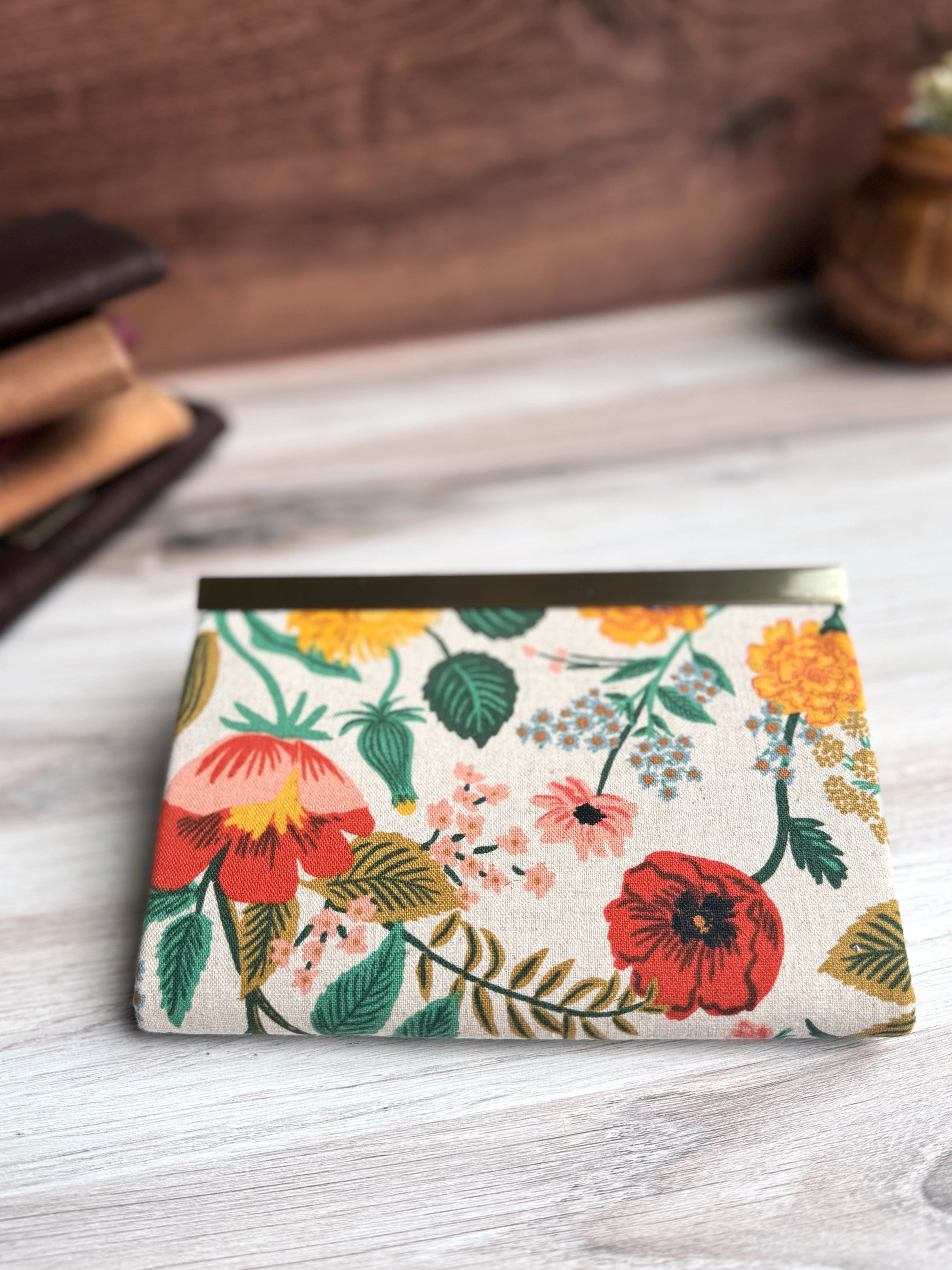 Back View of floral canvas accordion wallet with Rifle Paper fabric, antique brass closure clasp along top edge