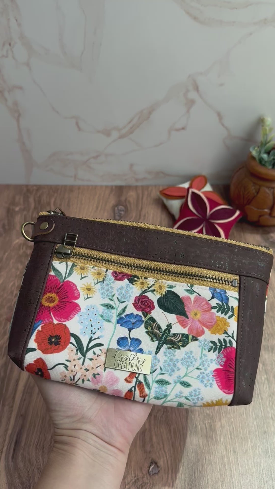 Erin zipper pouch is shown front, back, and inside pockets showing variety of floral fabrics, brown cork trim, and yellow brass zippers.