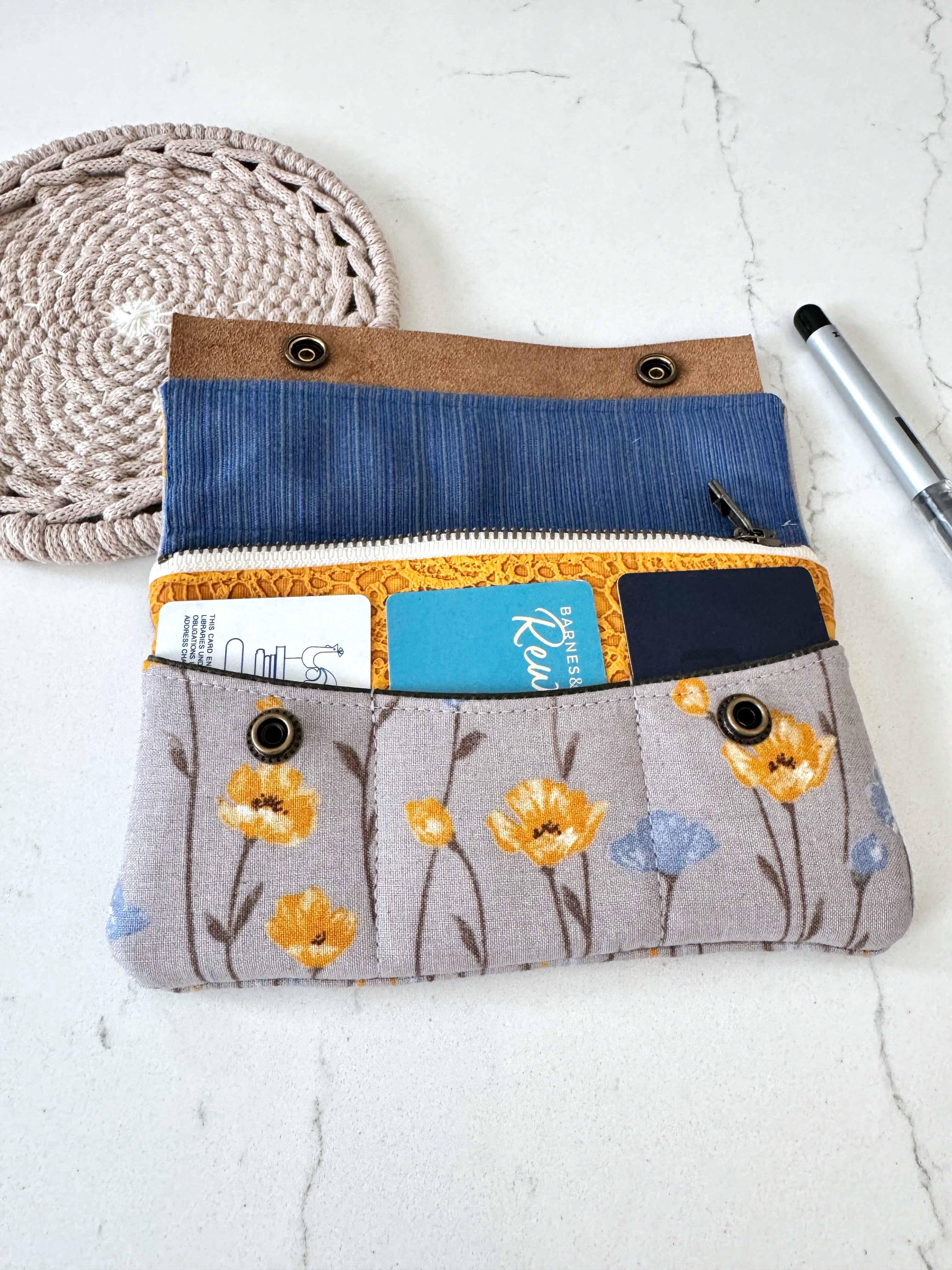 Fabric pouch with floral pattern on a white surface