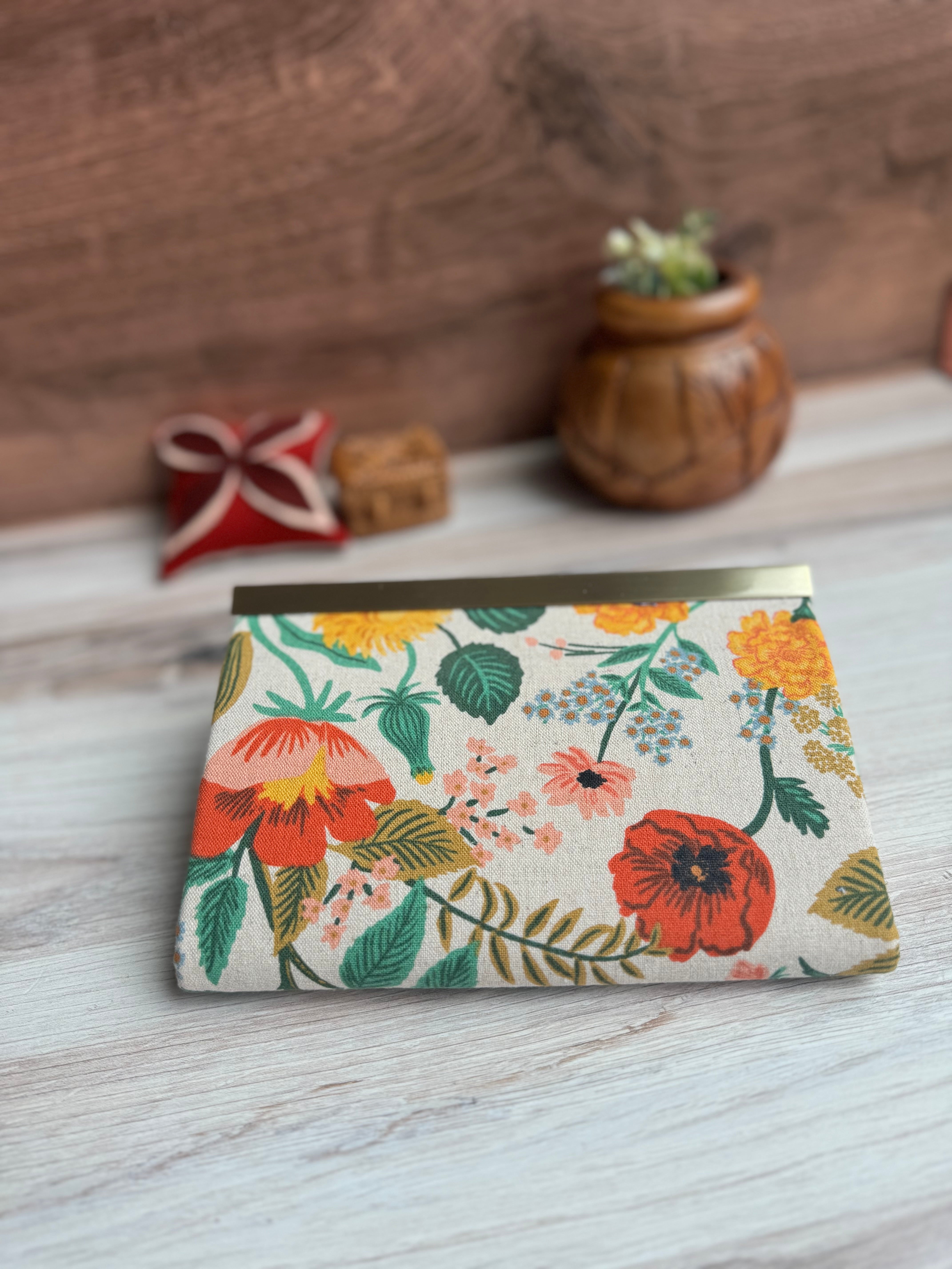 Floral canvas accordion wallet with Rifle Paper fabric, antique brass closure clasp along top edge and KrisChris antique brass label