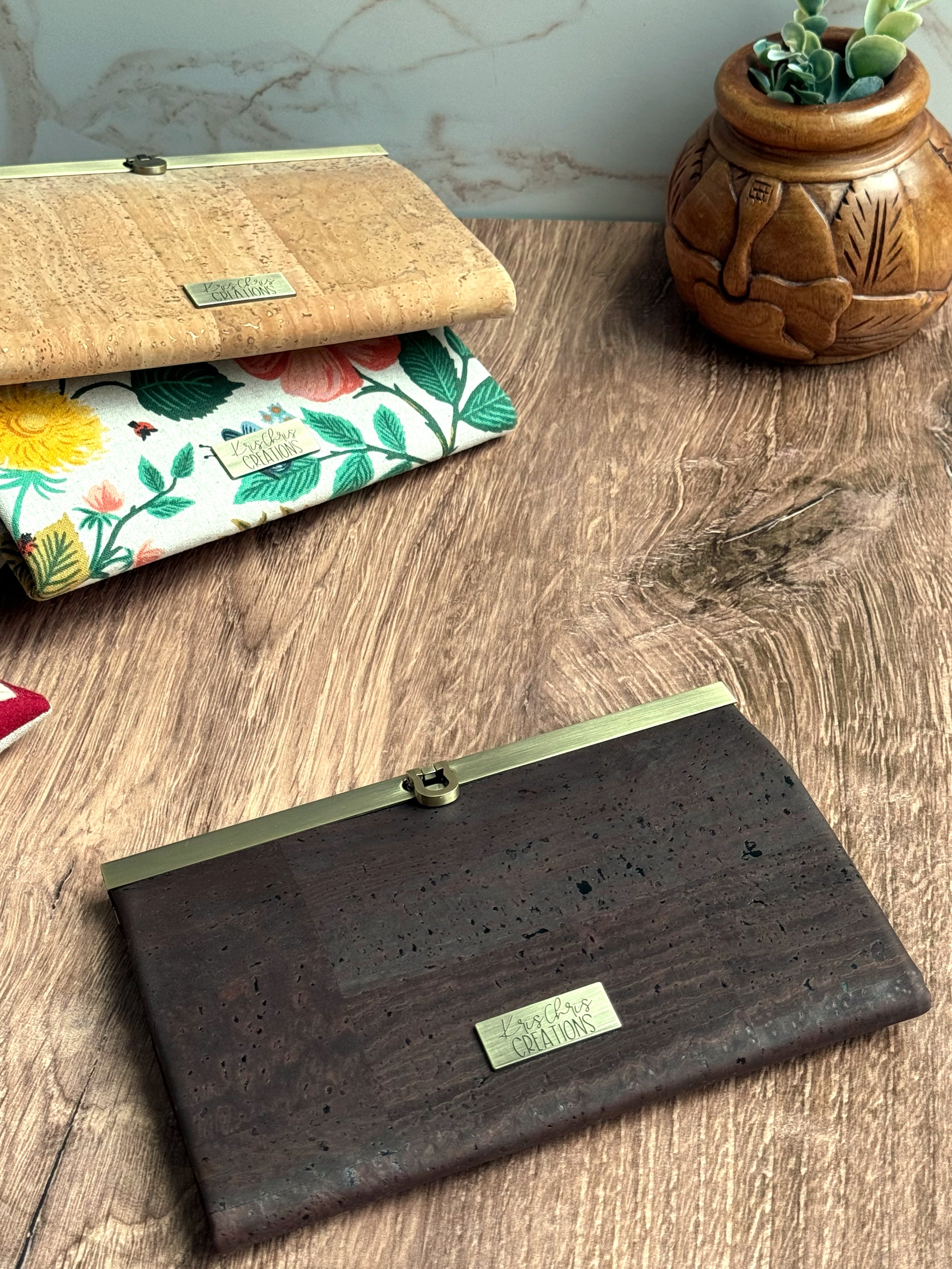 Dark brown cork accordion style wallet with a sleek exterior, antique brass metal clasp at top and coordinating KrisChris metal label.