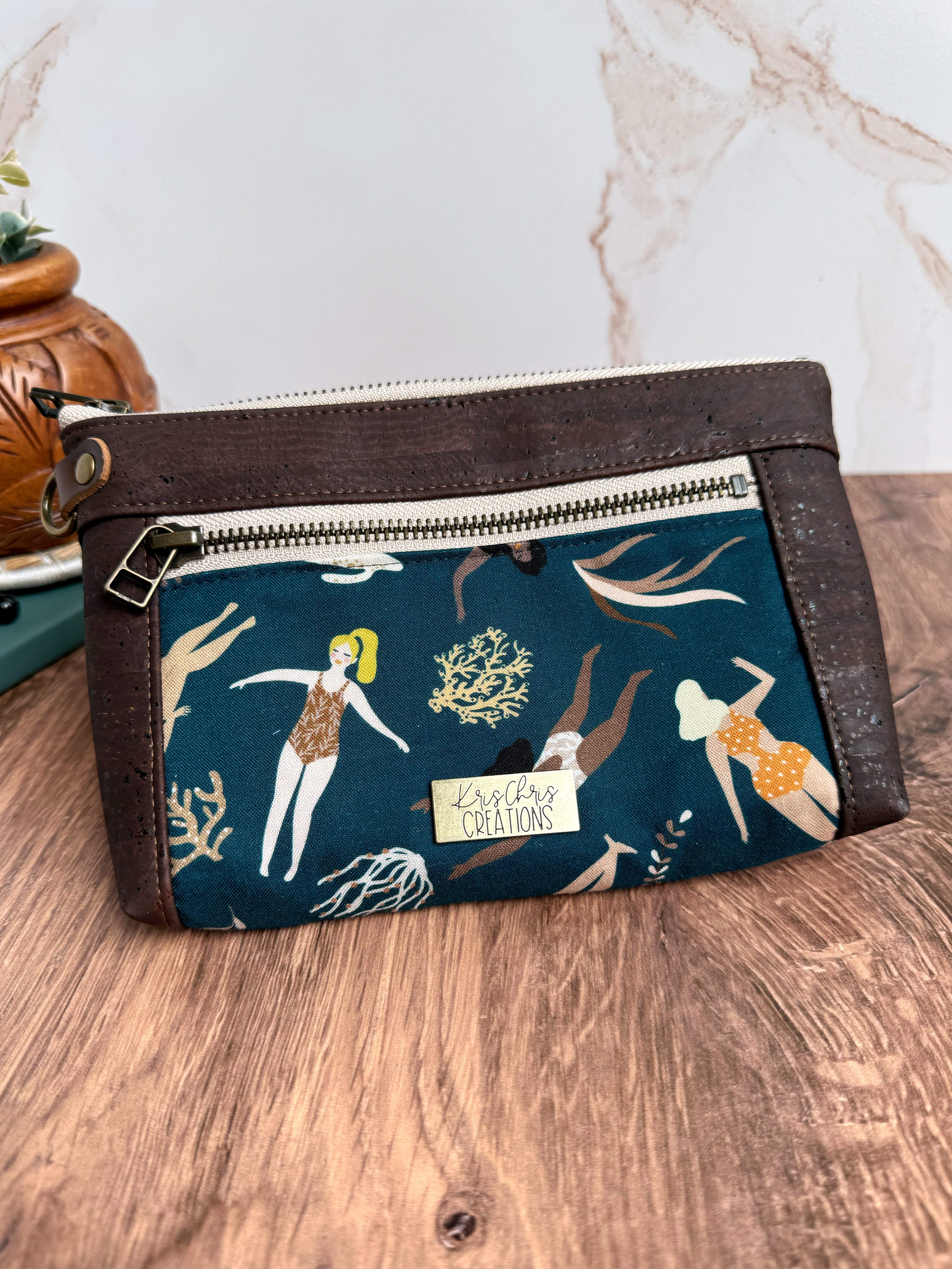 Chocolate brown cork trim pouch with dark teal fabric featuring ladies in bathing suits swimming 