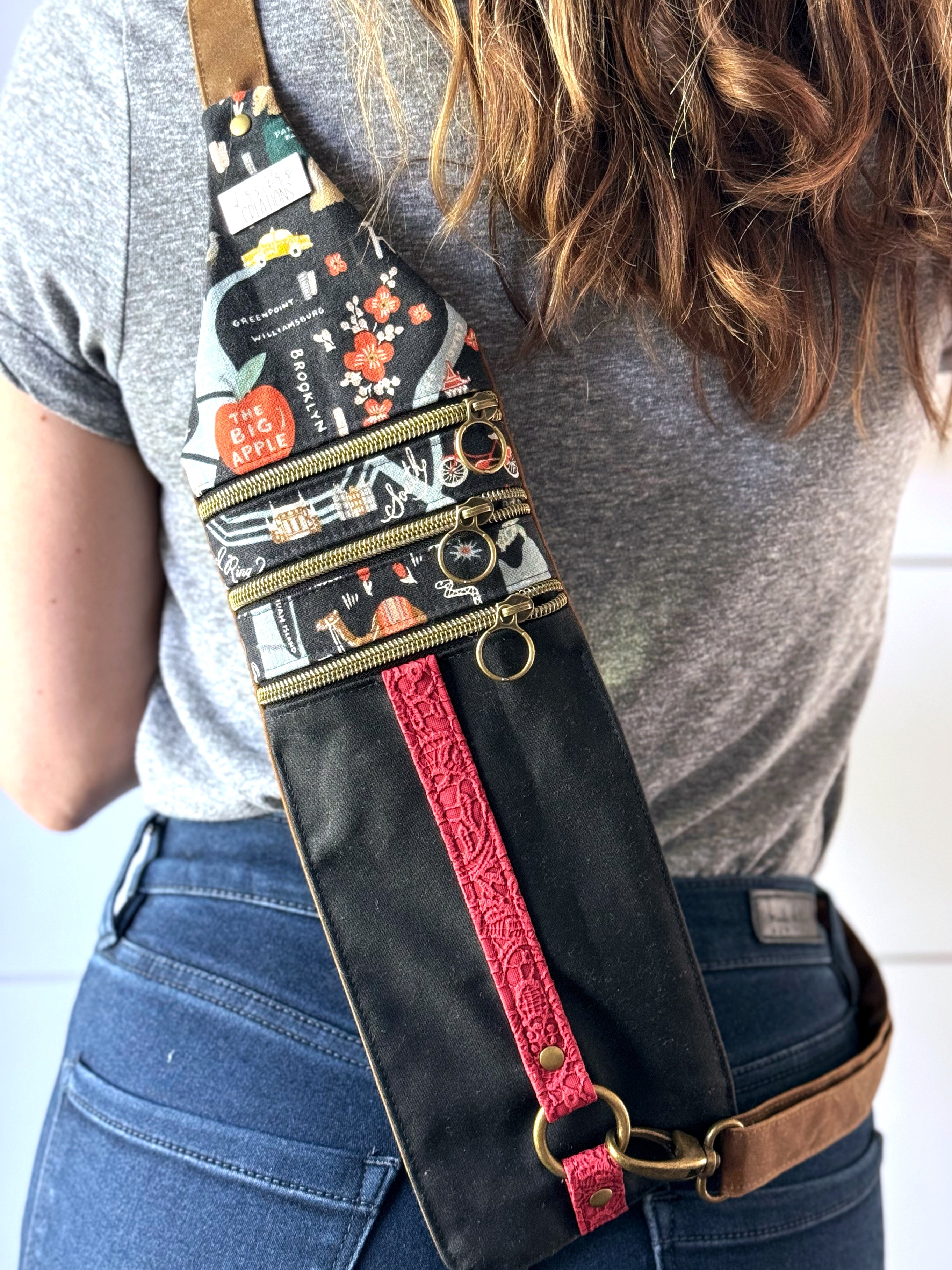 New York City Rifle Paper bag worn across woman's bag with red striped lace vinyl