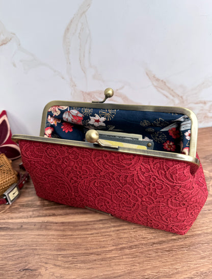 Opened red lace vinyl kisslock clutch bag