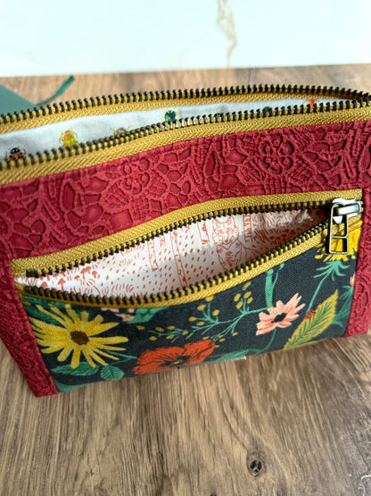 Floral pouch shows different illustrated fabrics inside zipper pockets.  Colors of yellow zipper trim, red lace vinyl, and Rifle Paper Co. canvas contrast.