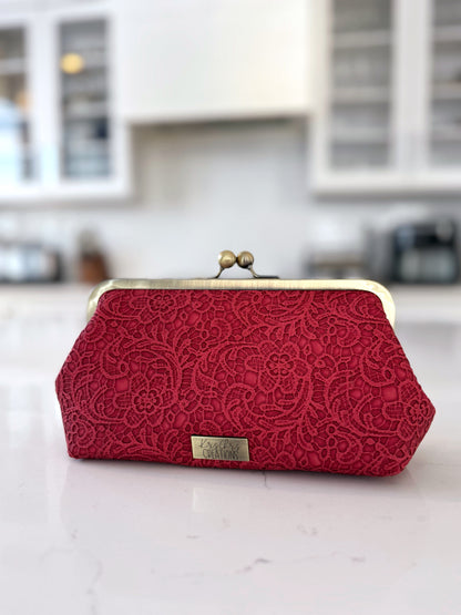 Red kisslock clutch in a white kitchen