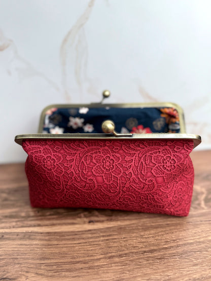 Opened red clutch bag with rear edge out of focus