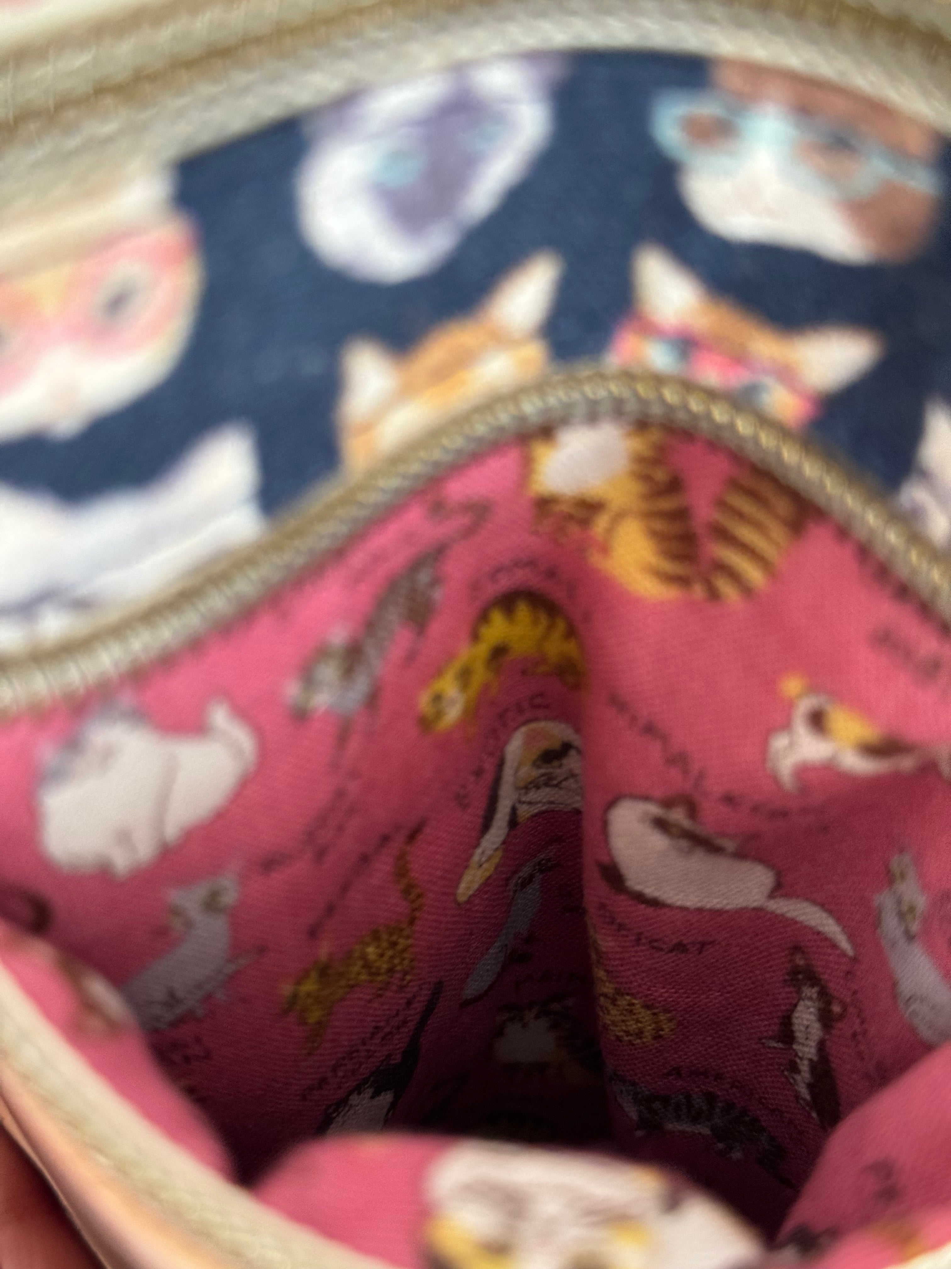 The inside of a pocket reveals adorable  cats with pink background fabric with names of their breeds below each one. 
