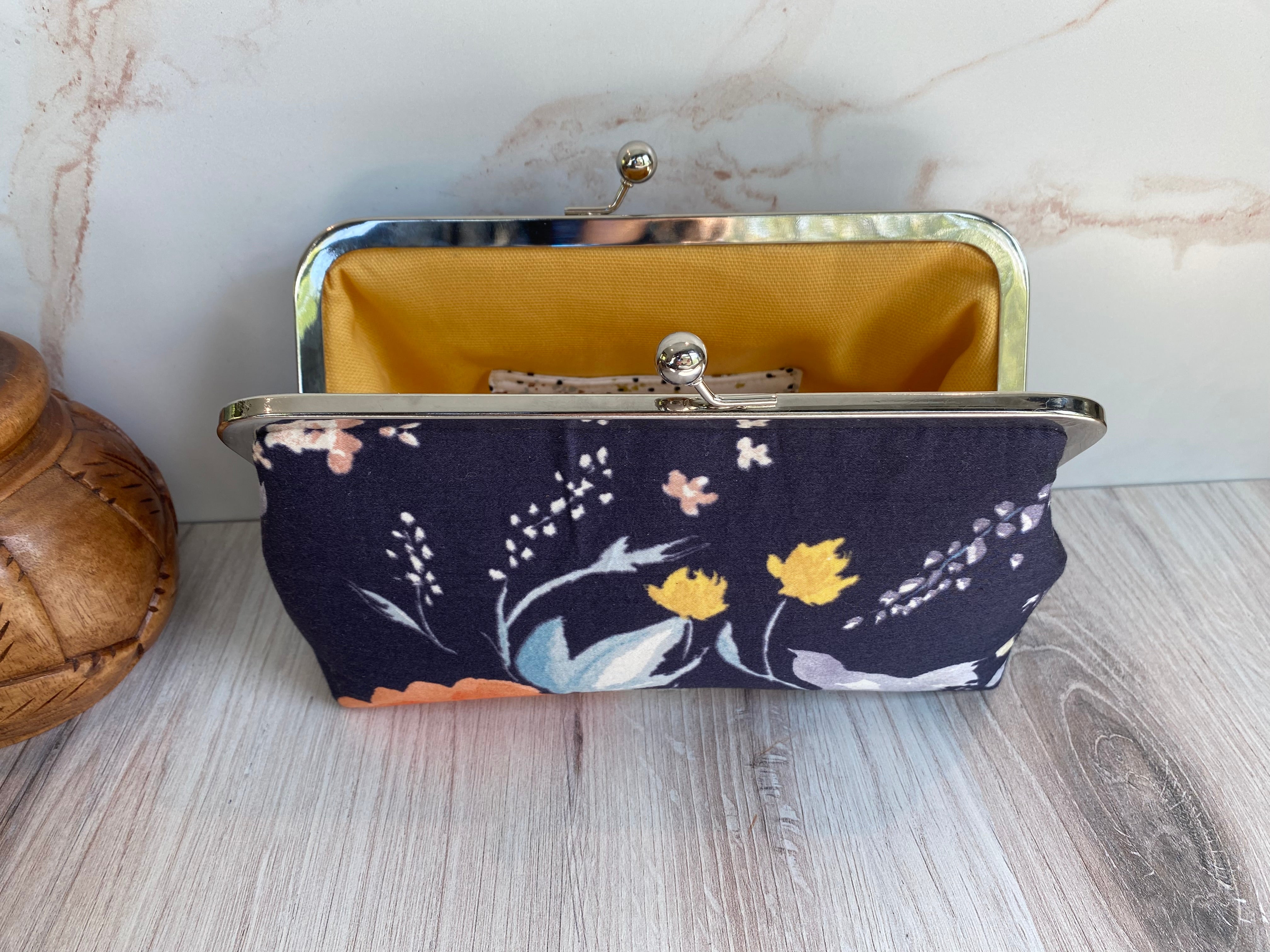 Twist Lock Clutch with Silver hardware and navy Nani Iro watercolor floral fabric with yellow canvas lining.