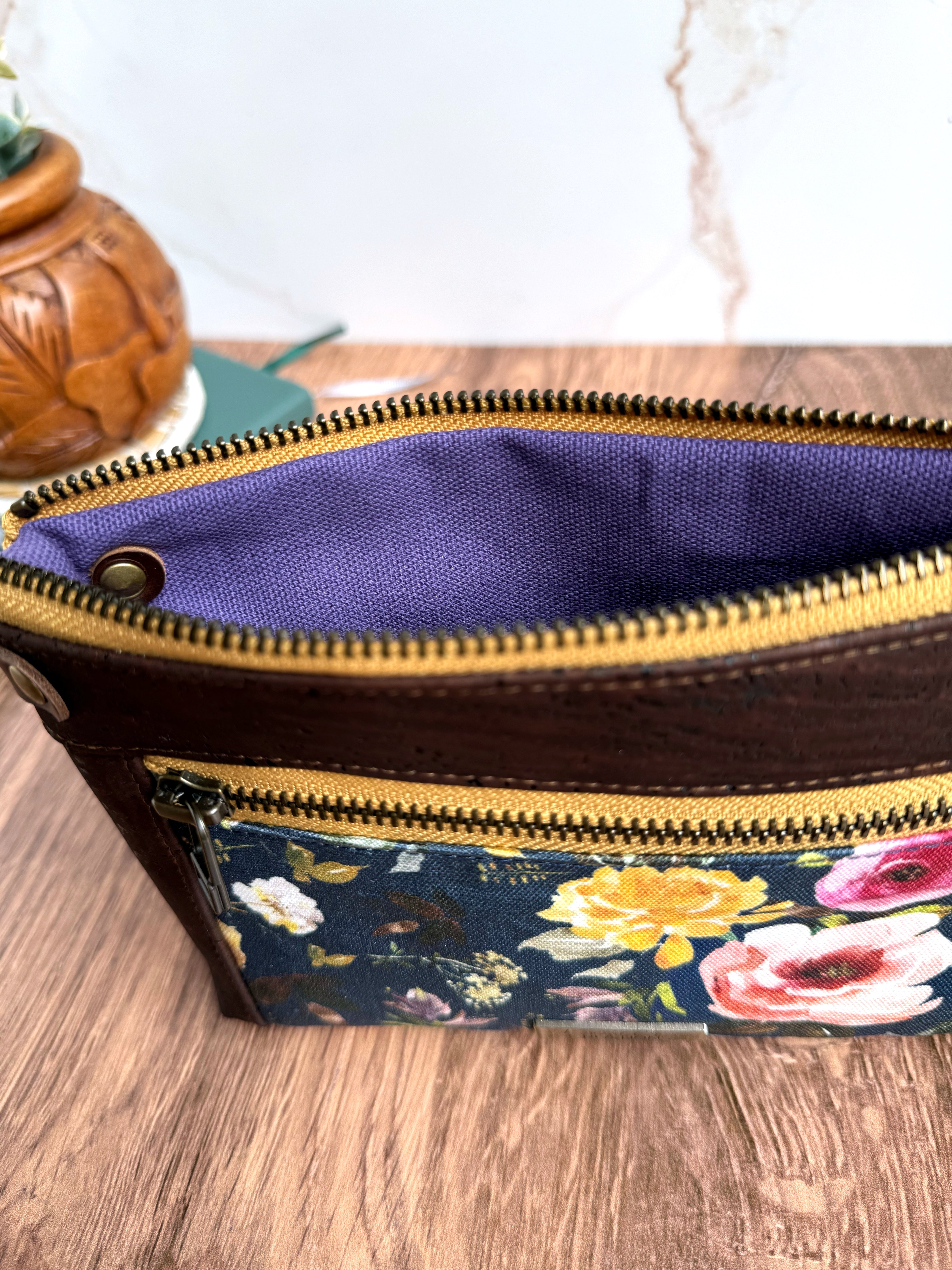 Chocolate cork trim and floral pouch is open to show purple canvas fabric lining.