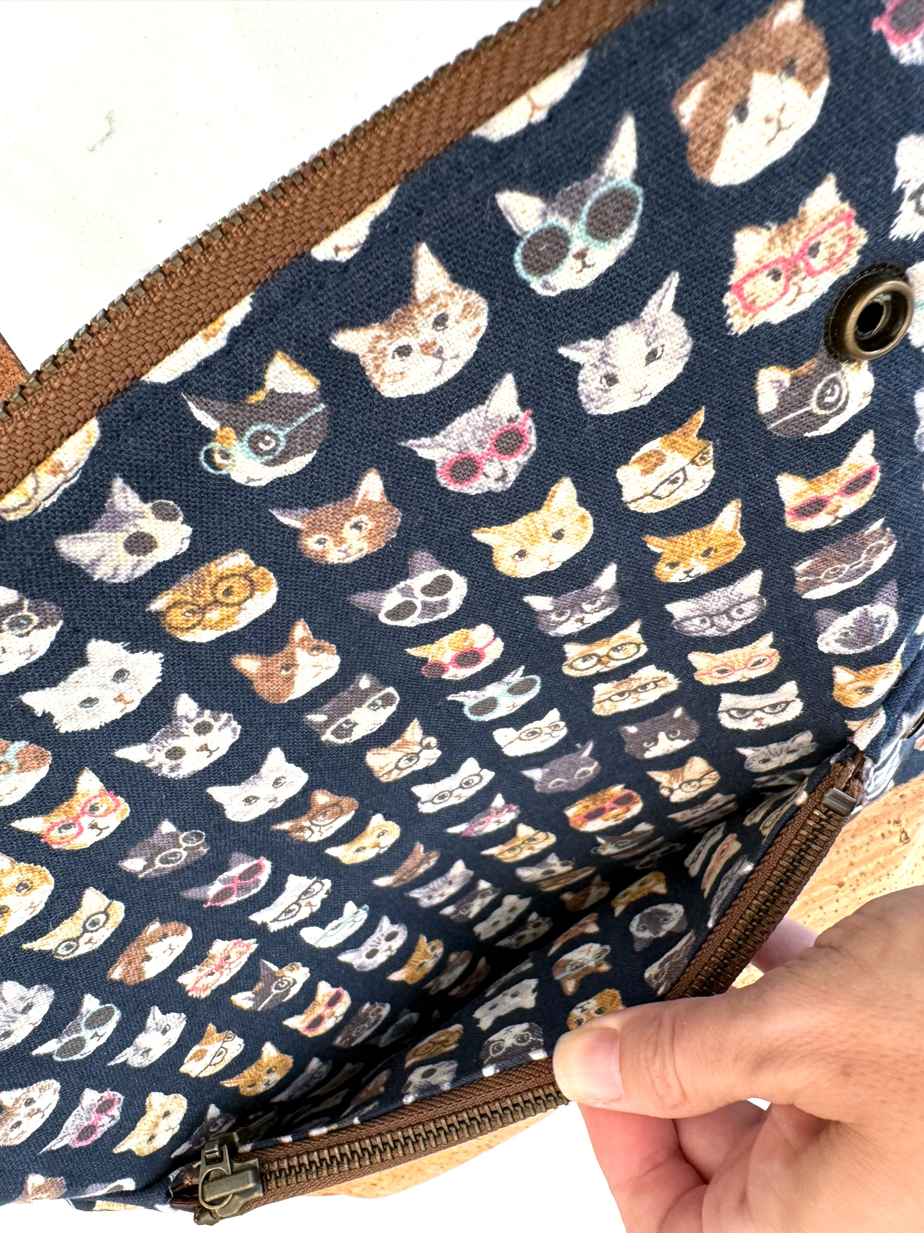 Interior of cat clutch when opened to show pocket behind interior zipper.  Useful for papers or cash.