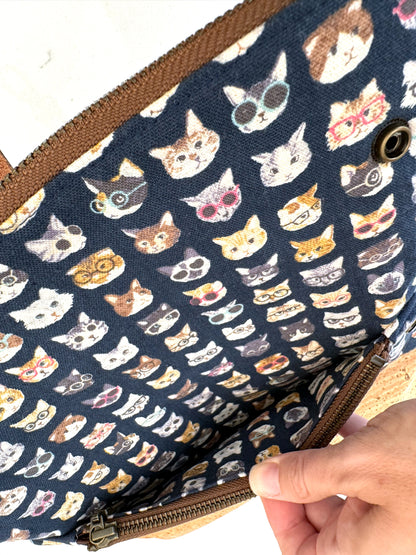 Interior of cat clutch when opened to show pocket behind interior zipper.  Useful for papers or cash.