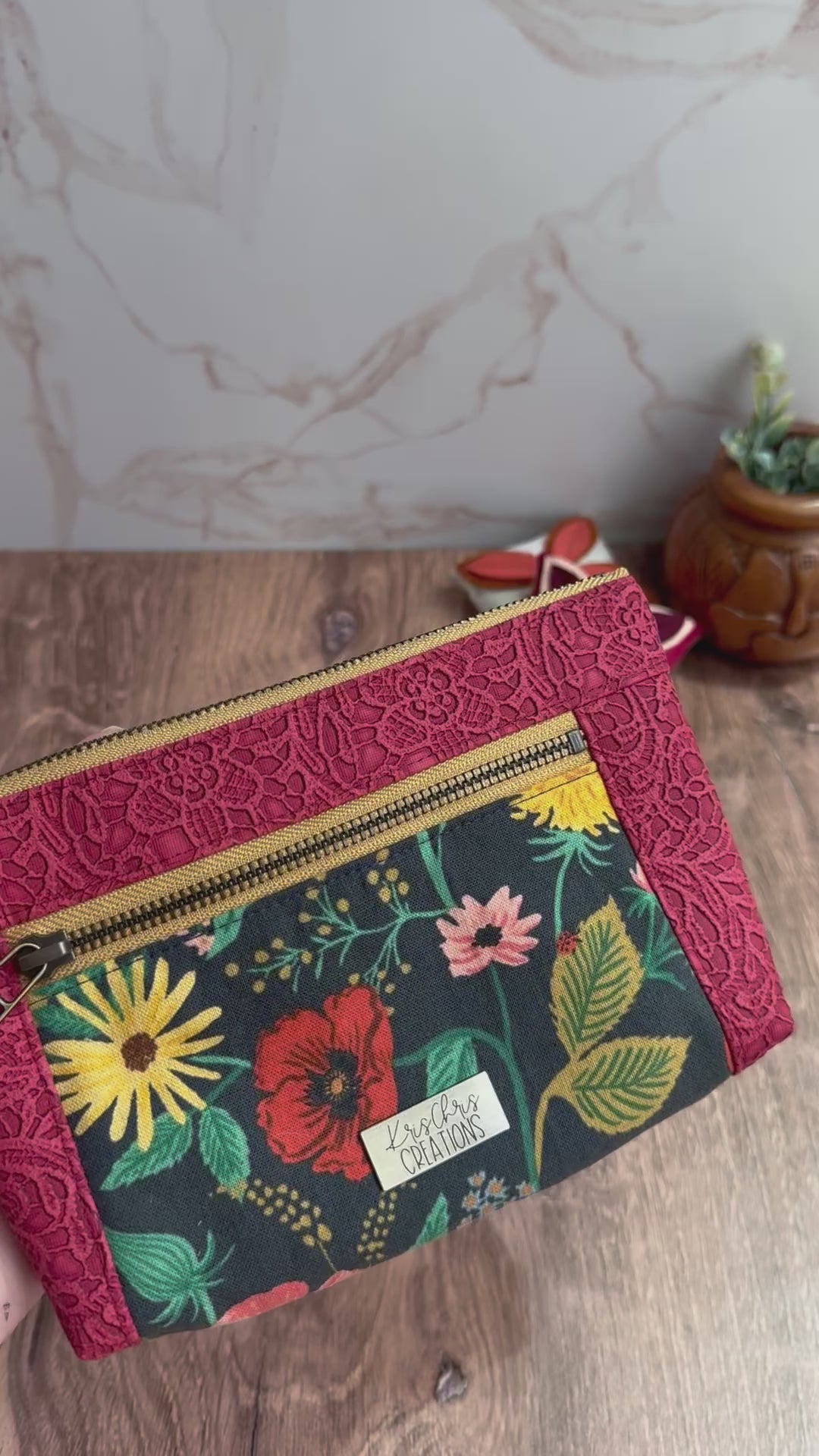 Double zipper pouch opens to show different illustrated fabric interiors with woodland scenes and bug fabrics. 